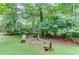 A charming backyard with a rustic fire pit area and wooden chairs, perfect for outdoor gatherings at 2291 Smokehouse Path, Lawrenceville, GA 30044