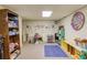 Playroom in the basement with colorful art and built-in storage for toys and books at 2291 Smokehouse Path, Lawrenceville, GA 30044