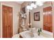Cozy half bathroom with wood accents and modern fixtures at 2291 Smokehouse Path, Lawrenceville, GA 30044