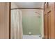 Bathroom with shower/tub combo, green tile, and shower curtain at 2291 Smokehouse Path, Lawrenceville, GA 30044