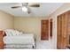 Serene bedroom with a plush bed, ceiling fan, and dark wooden doors and trim throughout at 2291 Smokehouse Path, Lawrenceville, GA 30044