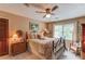 Cozy bedroom with ceiling fan, window, and quaint furnishings at 2291 Smokehouse Path, Lawrenceville, GA 30044
