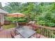 Inviting outdoor deck with table, chairs, umbrella, and a relaxing porch swing at 2291 Smokehouse Path, Lawrenceville, GA 30044