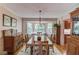 Formal dining room boasts a bay window and wooden furniture under the chandelier at 2291 Smokehouse Path, Lawrenceville, GA 30044