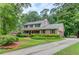 Inviting two-story brick home with a long driveway, lush front yard, and attached two car garage at 2291 Smokehouse Path, Lawrenceville, GA 30044