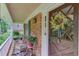 Cozy front porch featuring rocking chairs, plants, and a charming front door with a decorative wreath at 2291 Smokehouse Path, Lawrenceville, GA 30044