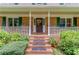 Close-up of the front porch with brick steps, white railing, and a decorative wreath on the front door at 2291 Smokehouse Path, Lawrenceville, GA 30044
