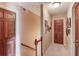 Upstairs hallway with neutral colored walls, wood trim, carpet, and doors at 2291 Smokehouse Path, Lawrenceville, GA 30044