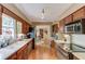Galley style kitchen features wood cabinets, stainless appliances, and hardwood flooring at 2291 Smokehouse Path, Lawrenceville, GA 30044