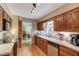 Well-maintained kitchen features wood cabinets, stainless appliances, and hardwood flooring at 2291 Smokehouse Path, Lawrenceville, GA 30044