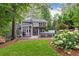 Lush backyard featuring a hot tub, outdoor seating area, and mature trees creating a private oasis at 3072 Dale Ne Dr, Atlanta, GA 30305