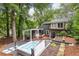The backyard includes a hot tub, grilling area, and multi-tiered deck with seating and natural shade at 3072 Dale Ne Dr, Atlanta, GA 30305