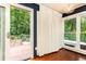 An indoor/outdoor balcony area features a modern light fixture and a large window to the backyard at 3072 Dale Ne Dr, Atlanta, GA 30305