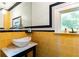 Bright and airy bathroom featuring yellow tile, a marble sink, and unique black and white accents at 3072 Dale Ne Dr, Atlanta, GA 30305