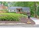 Charming home featuring manicured lawn, gray siding, and a cozy front porch with seating at 3072 Dale Ne Dr, Atlanta, GA 30305