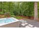 Tranquil backyard setting with a modern hot tub and a stone pathway leading through lush greenery at 3072 Dale Ne Dr, Atlanta, GA 30305