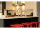 Stylish kitchen island with barstool seating, modern fixtures, and white subway tile backsplash at 3072 Dale Ne Dr, Atlanta, GA 30305