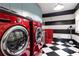 Modern laundry room featuring a dog washing station, striking red machines, and black and white floors at 3072 Dale Ne Dr, Atlanta, GA 30305