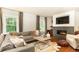 Bright living room with a fireplace, hardwood floors, and comfortable seating area at 3072 Dale Ne Dr, Atlanta, GA 30305