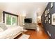 Bright main bedroom featuring hardwood floors, a private en suite, and access to a balcony at 3072 Dale Ne Dr, Atlanta, GA 30305
