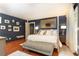 A luxurious main bedroom features a four-poster bed, accent wall, and cherry-colored hardwood floors at 3072 Dale Ne Dr, Atlanta, GA 30305