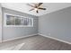 Bedroom with a ceiling fan, natural light, and stylish gray flooring at 3236 Henderson Mill Rd # 5, Atlanta, GA 30341
