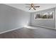 Bedroom with a ceiling fan, natural light, and stylish gray flooring at 3236 Henderson Mill Rd # 5, Atlanta, GA 30341