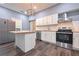 Modern kitchen featuring white cabinets, stainless steel appliances and hardwood floors at 7880 Rivertown Rd, Fairburn, GA 30213