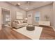 Bright living room featuring hardwood floors, recessed lighting, and a comfortable sofa at 7880 Rivertown Rd, Fairburn, GA 30213