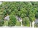 Aerial view of a home with green lawn, surrounded by lush, mature trees creating a private, natural setting at 2105 Huntington Hills Trce, Buford, GA 30519