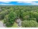 Picturesque aerial view of a home surrounded by a dense forest, showcasing its serene and secluded location at 2105 Huntington Hills Trce, Buford, GA 30519