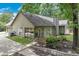 Charming home exterior with a well-maintained lawn, beautiful landscaping, and a screened-in porch area at 2105 Huntington Hills Trce, Buford, GA 30519