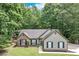 Charming one-story home with a mix of brick and siding, surrounded by mature trees and well-kept lawn at 2105 Huntington Hills Trce, Buford, GA 30519