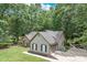Well-maintained home featuring neutral siding, black shutters, and an attached garage in a lush, green setting at 2105 Huntington Hills Trce, Buford, GA 30519
