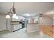 Well-lit kitchen features white cabinets, stainless steel appliances, and neutral tile flooring at 2105 Huntington Hills Trce, Buford, GA 30519