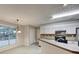 Cozy kitchen with white cabinetry, breakfast bar, and a window for natural light at 2105 Huntington Hills Trce, Buford, GA 30519