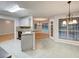 Bright kitchen with island, stainless appliances, and adjacent dining area at 2105 Huntington Hills Trce, Buford, GA 30519