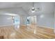 Expansive living room featuring hardwood floors, a modern ceiling fan, and an open layout for seamless entertaining at 2105 Huntington Hills Trce, Buford, GA 30519
