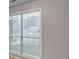 Bright room featuring a window covered with light filtering blinds at 2105 Huntington Hills Trce, Buford, GA 30519