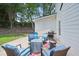 Backyard patio area with gas grill and several blue chairs at 4365 Mantle Ridge Dr, Cumming, GA 30041