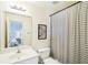 Clean bathroom featuring a single vanity, toilet and shower/tub combination with a striped curtain at 4365 Mantle Ridge Dr, Cumming, GA 30041