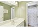 Bathroom with a single sink, decorative mirror, and shower/tub combo at 4365 Mantle Ridge Dr, Cumming, GA 30041
