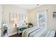 Comfortable bedroom featuring hardwood floors, decorative console table, and bright natural lighting at 4365 Mantle Ridge Dr, Cumming, GA 30041
