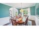 Bright dining room showcases hardwood floors, a stylish chandelier, and an arched doorway to the foyer at 4365 Mantle Ridge Dr, Cumming, GA 30041