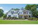 Inviting two-story home featuring manicured landscaping, a stone accent wall, and classic black shutters at 4365 Mantle Ridge Dr, Cumming, GA 30041