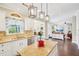 Open concept kitchen with granite counters and white cabinets flowing into a living room and dining space at 4365 Mantle Ridge Dr, Cumming, GA 30041