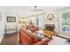 Spacious living room features hardwood floors, a stone fireplace, and seamless flow to the kitchen at 4365 Mantle Ridge Dr, Cumming, GA 30041