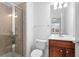 Bright bathroom featuring tiled shower, and a vanity with a white countertop and wood cabinets at 4874 Seldon Se Way, Smyrna, GA 30080