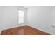 Cozy bedroom with hardwood floors, white trim, and a window with blinds at 4874 Seldon Se Way, Smyrna, GA 30080
