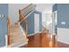 Elegant entryway with hardwood floors and a staircase with metal spindles at 4874 Seldon Se Way, Smyrna, GA 30080